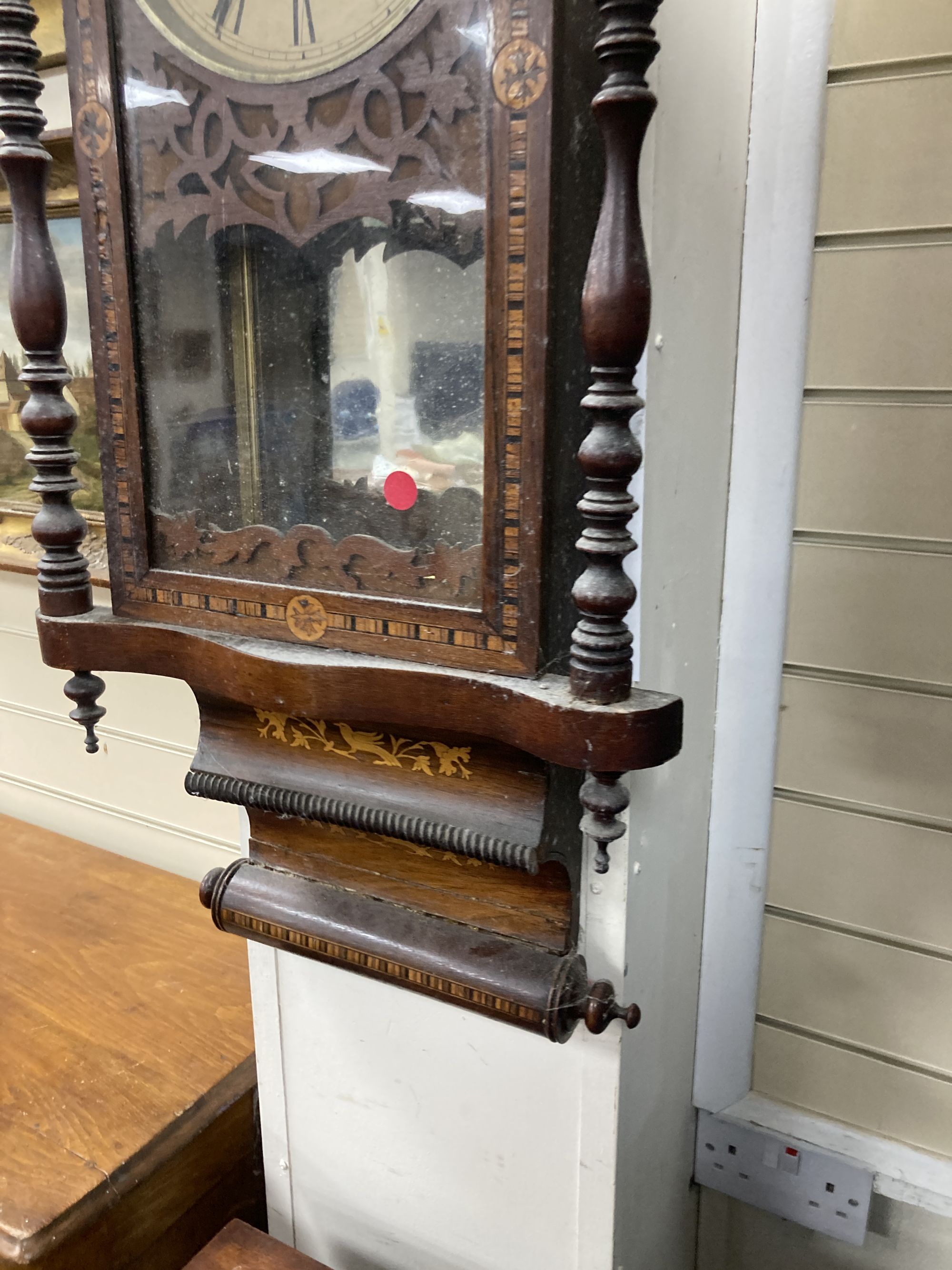 A 19th century American simulated rosewood wall clock, height 84cm, a 19th century inlaid wall clock and a mahogany pedestal cupboard